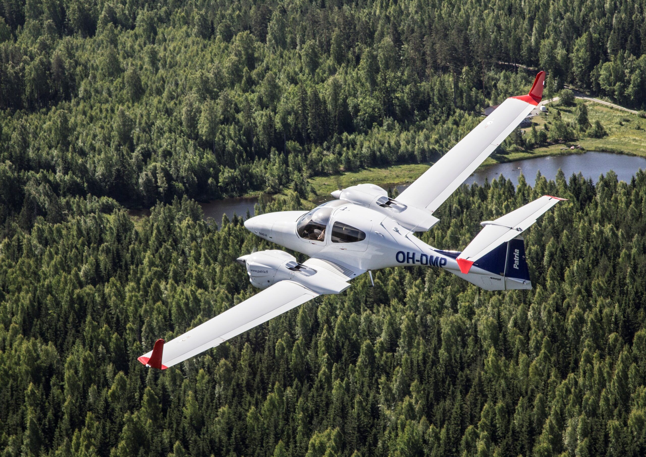 Patria - small plane flying over a forest